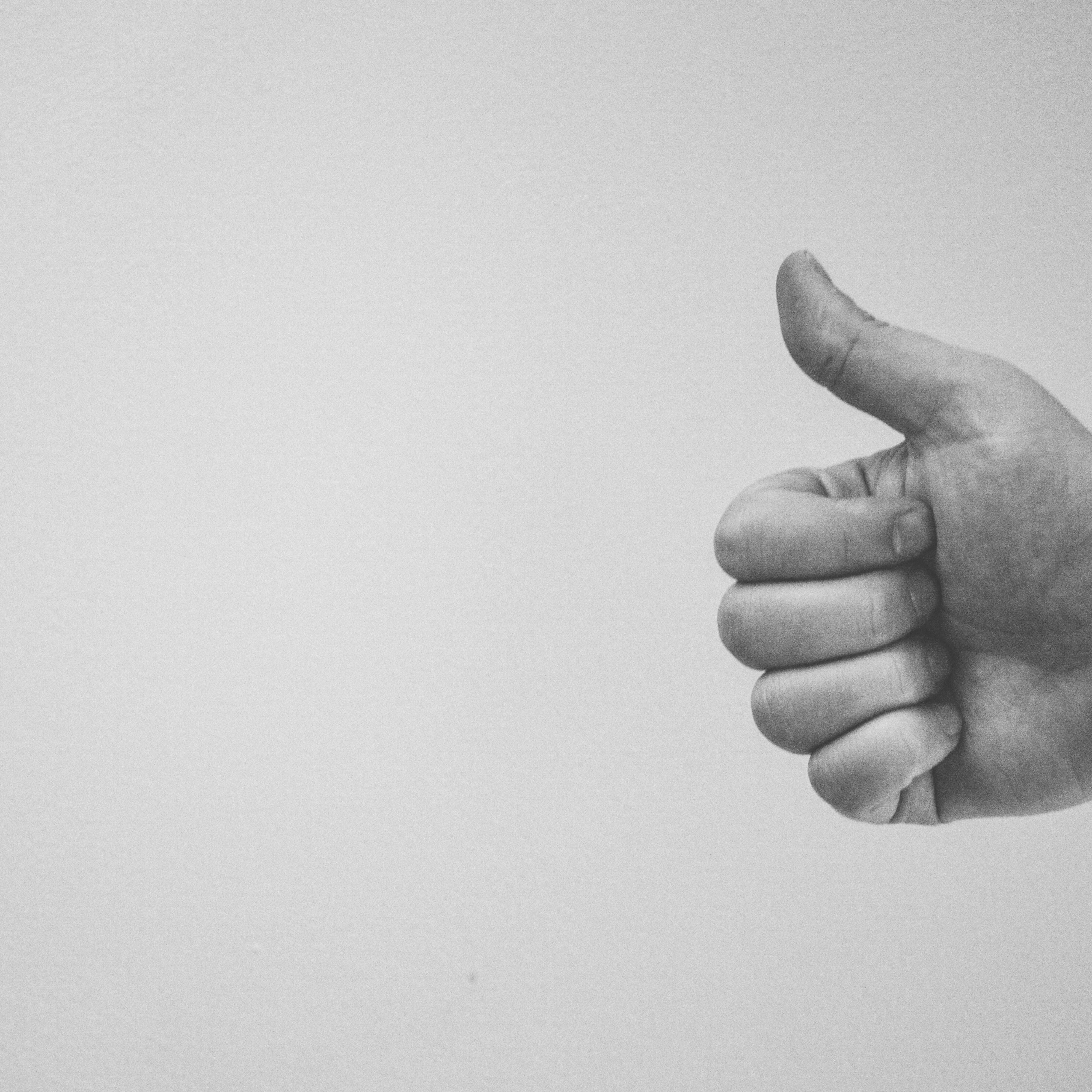 BW_HandGivesThumbsUpFromRight thumbs up in black and white