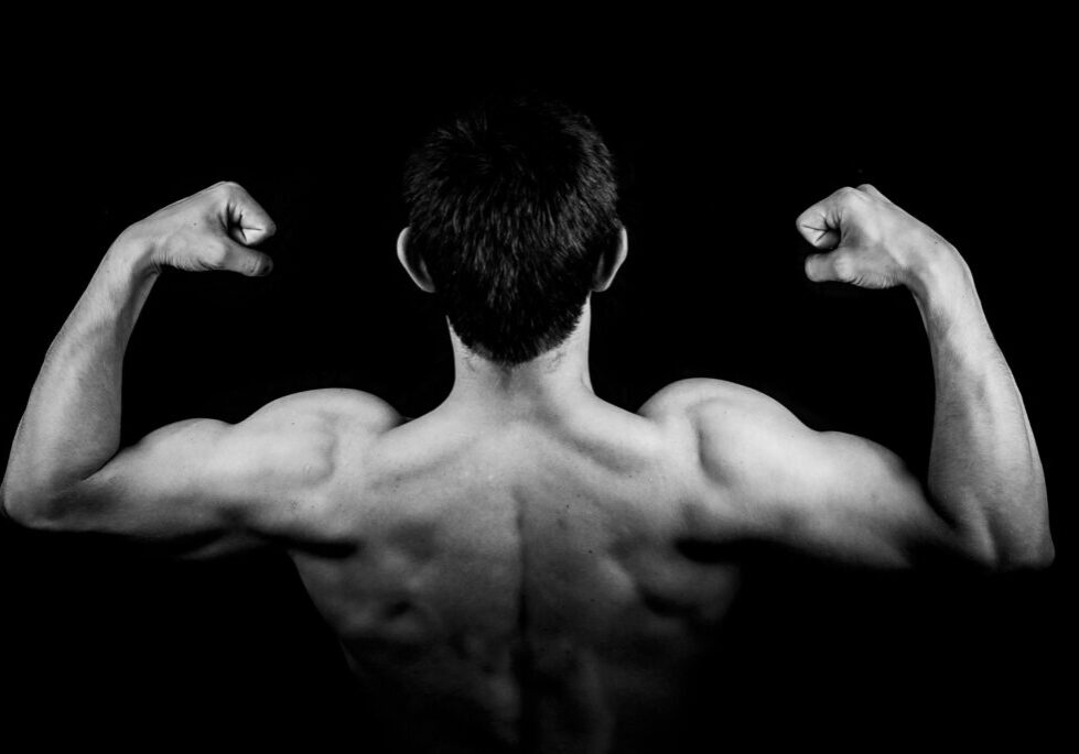 man's-upper-torso-seen from behind-flexing-strong-muscles