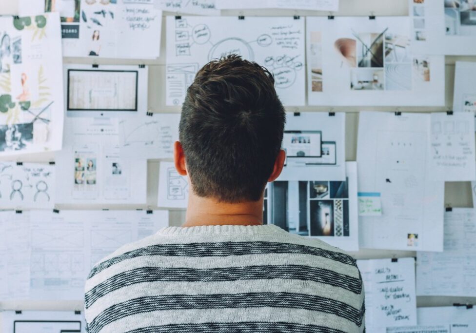 Man looks at vision board for nonprofit formation steps to get 501c3 status