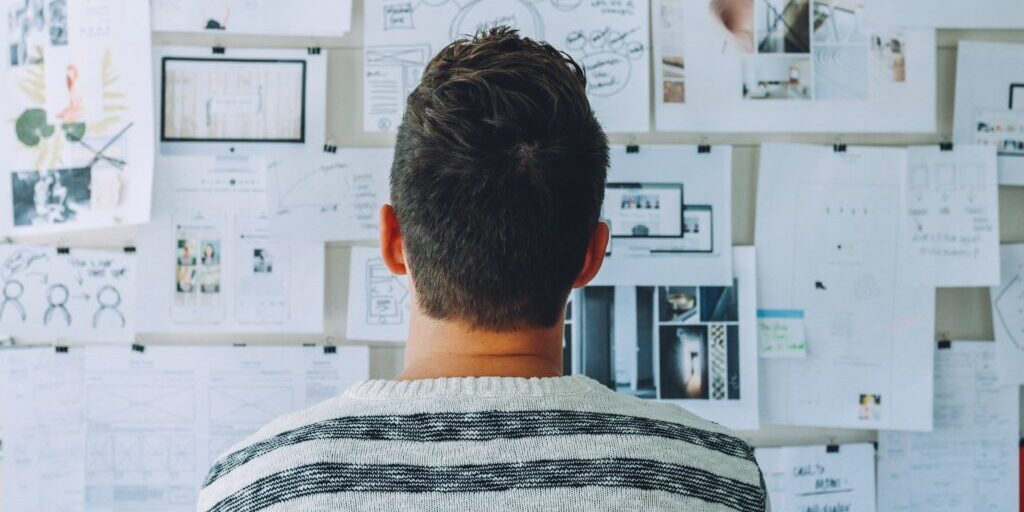 Man looks at vision board for nonprofit formation steps to get 501c3 status