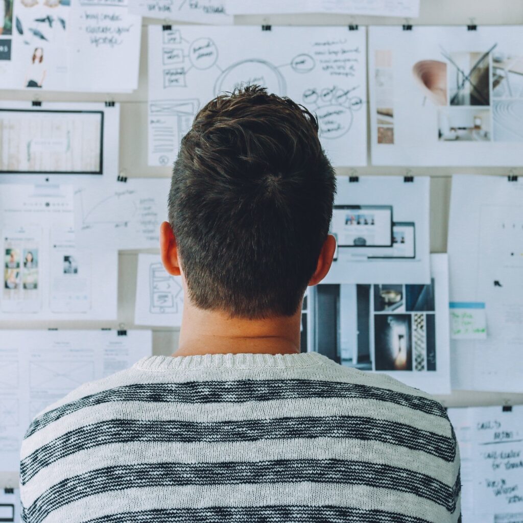 Man looks at vision board for nonprofit formation steps to get 501c3 status
